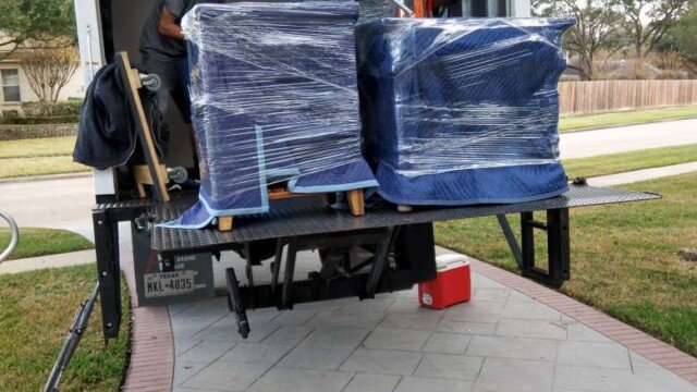 movers unpacking furnishings into new home